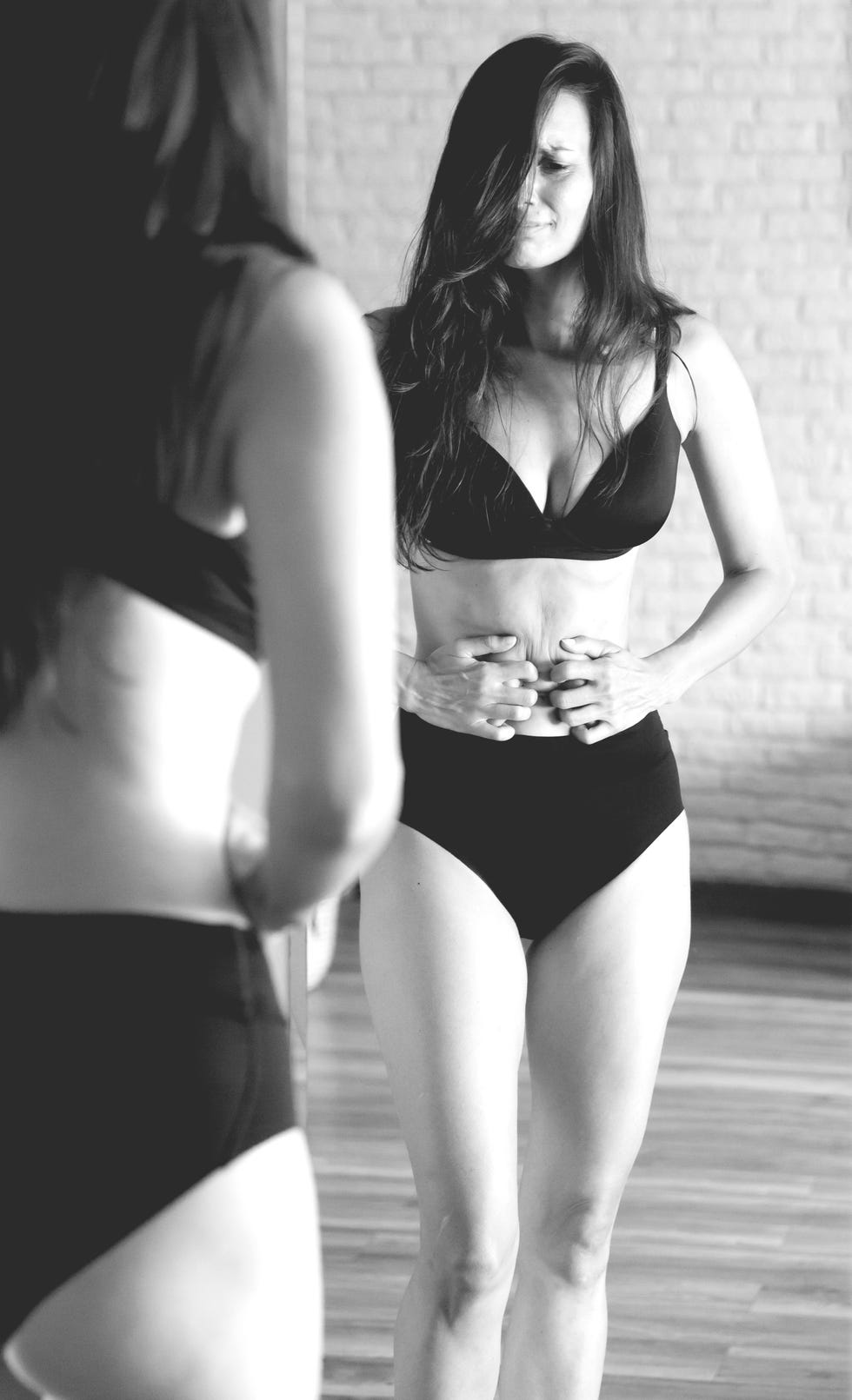 woman standing in front of a mirror with no makeup and criticise herself about her bodywith, displeased, unhappy, sad, sadness, depressed,woman, negativity, stressed, displeased, unhappy, sad, sadness, depressed,worried, feeling, indoors, expressing negativity, displeased, concern, caucasian, emotional, depression, unhappy, loneliness, sad, woman, expression, stress, sadness, young, person, depressed, problems, alone, despair, lonely, health, female, home, frustration, grief, adult, portrait, mental, anxiety, no makeup, fat, belly, black and white