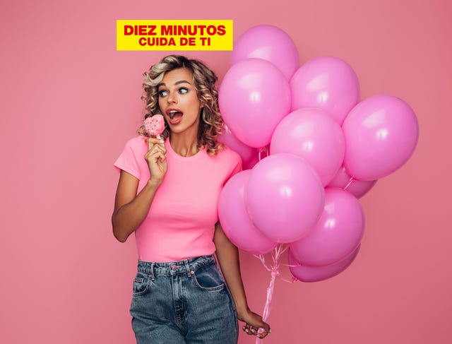 mujer, vestida de rosa, sostiene unos globos
