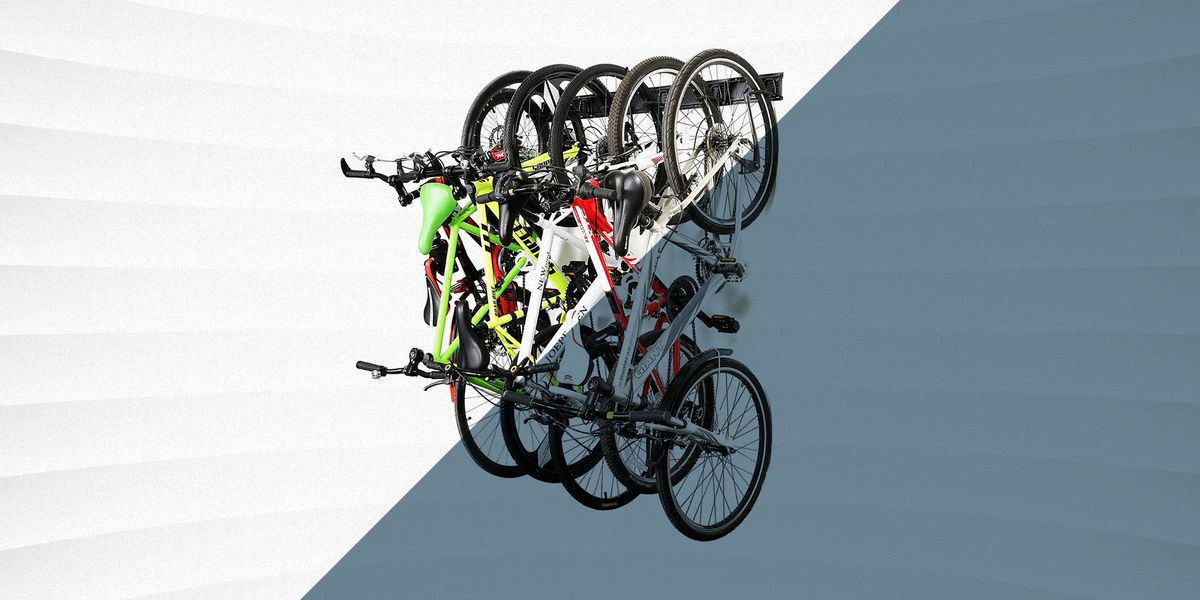 multiple bikes in wall mounted rack against gray and white background