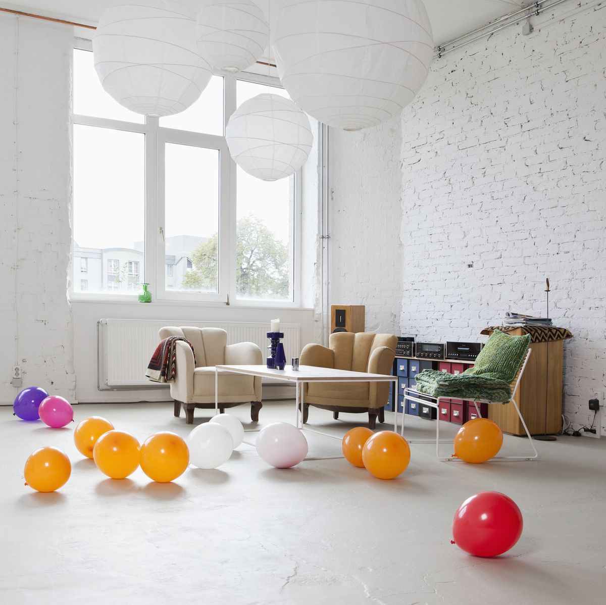 multi colored balloons on the floor of a modern living room
