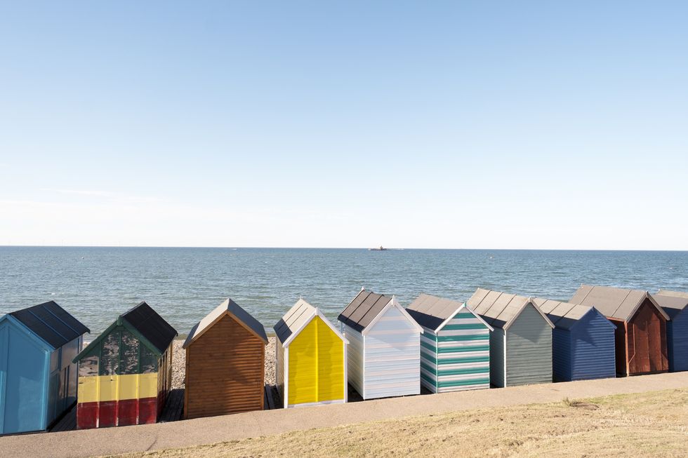 multi coloured beach huts by the sea