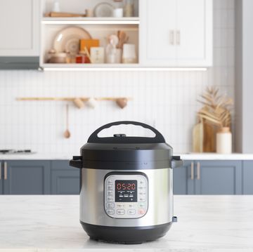 multi cooker on empty marble surface with blurred kitchen background