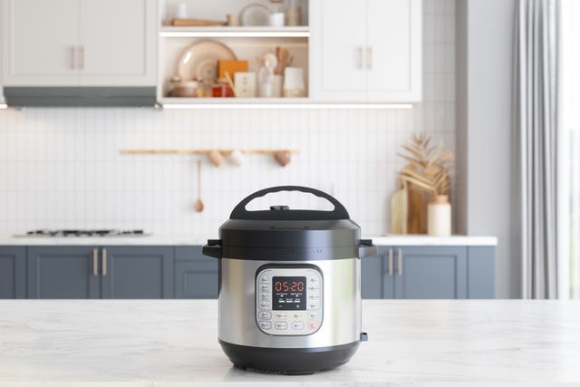 multi cooker on empty marble surface with blurred kitchen background