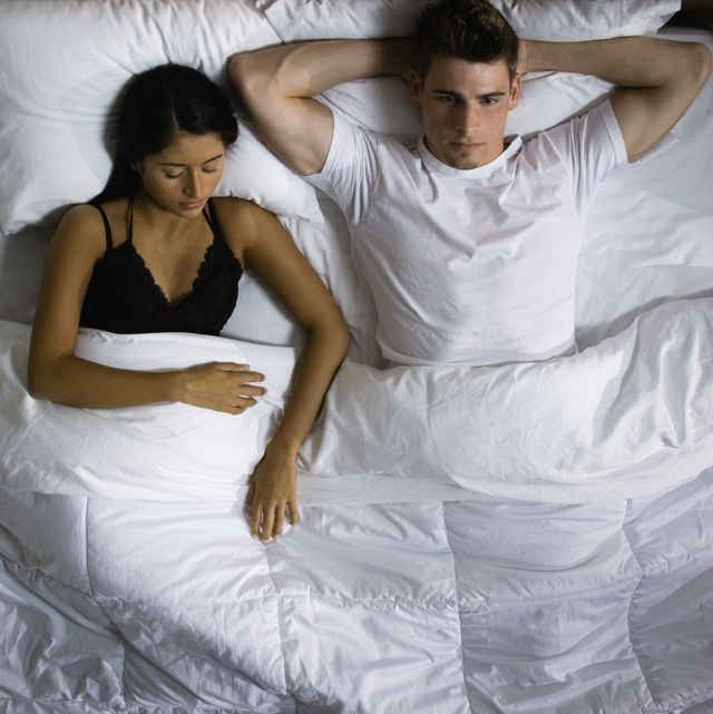 Multi-ethnic couple laying in bed