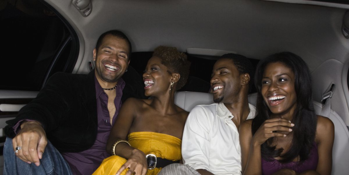 multi ethnic friends in back of limousine