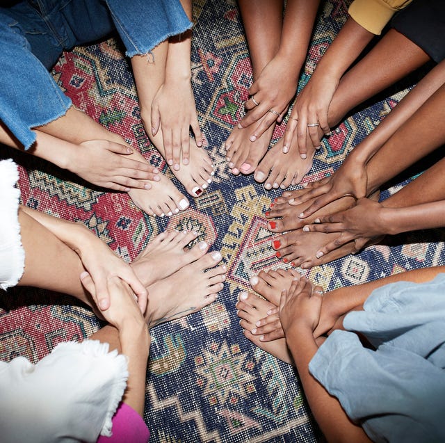 multi ethnic friends sitting together in circle on carpet