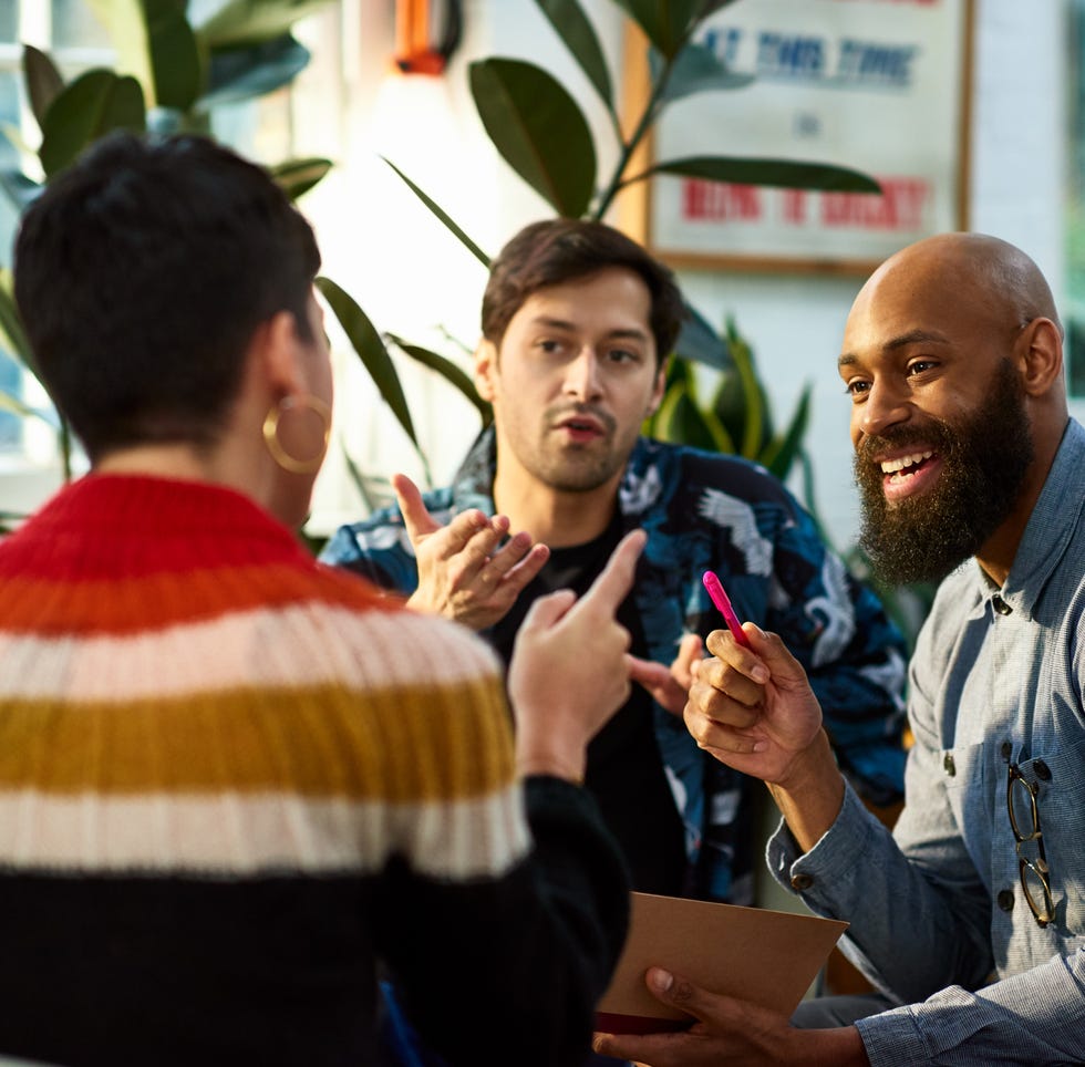 multi ethnic group sharing ideas in office