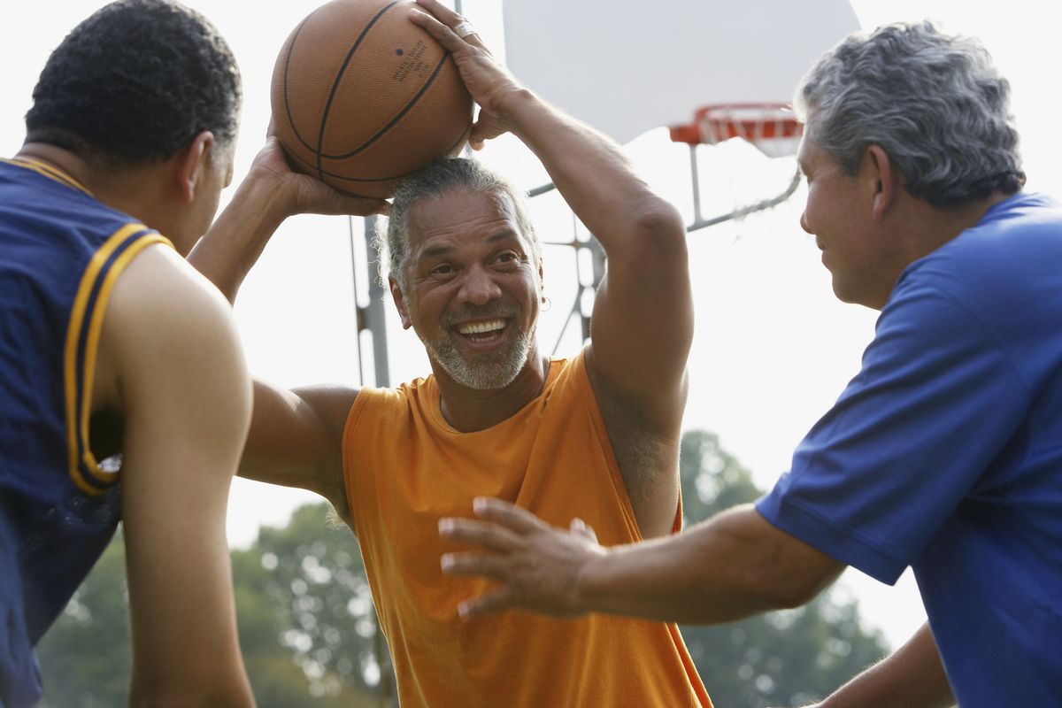 multi ethnic men playing basketball
