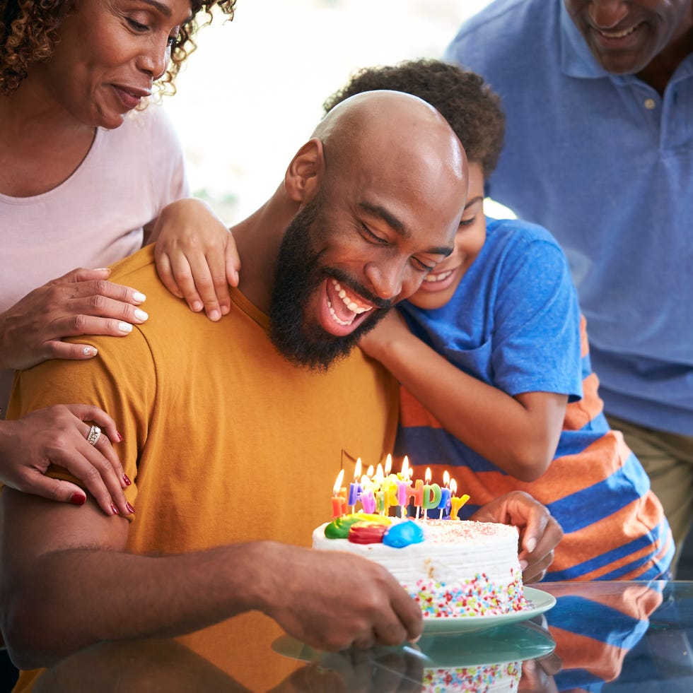 family celebrating fathers birthday at home together