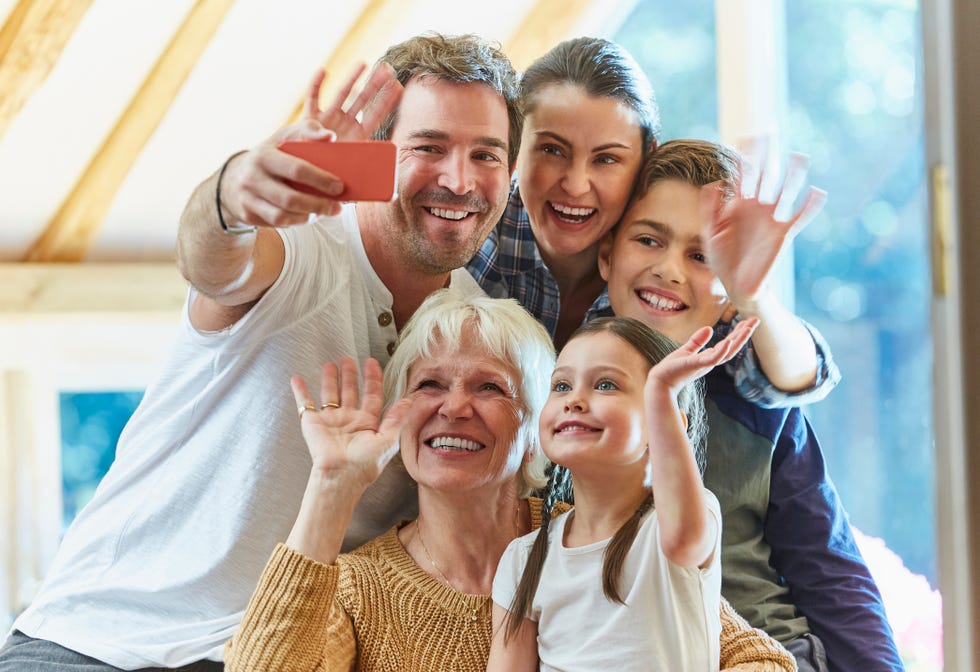 Multi-generation family waving and taking selfie