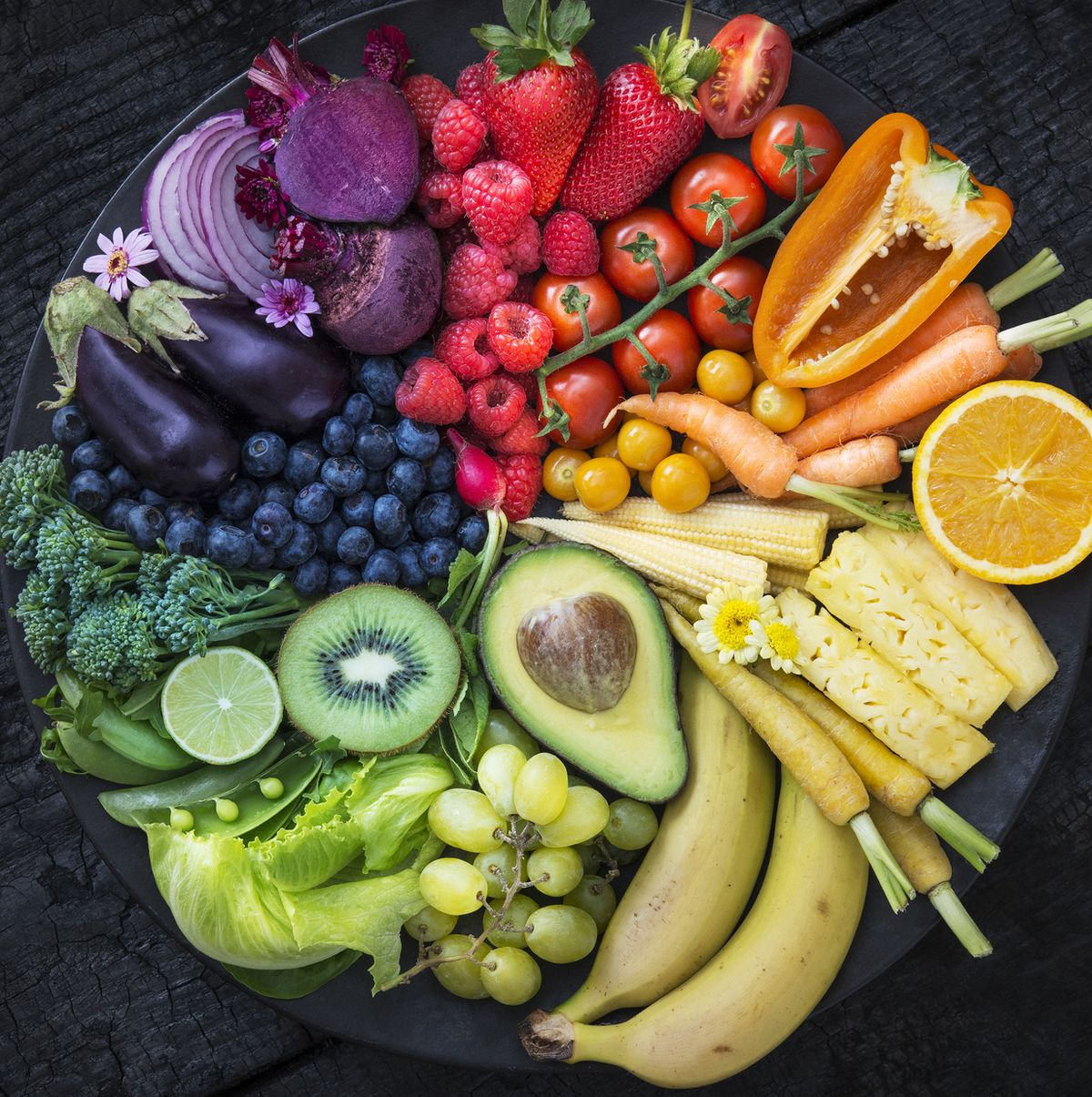 https://hips.hearstapps.com/hmg-prod/images/multicoloured-fruit-and-vegetables-in-a-black-bowl-royalty-free-image-1650038864.jpg?crop=0.636xw:0.798xh;0.184xw,0.118xh&resize=1200:*