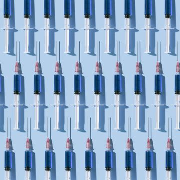 Multiple syringes organized in a pattern over blue background
