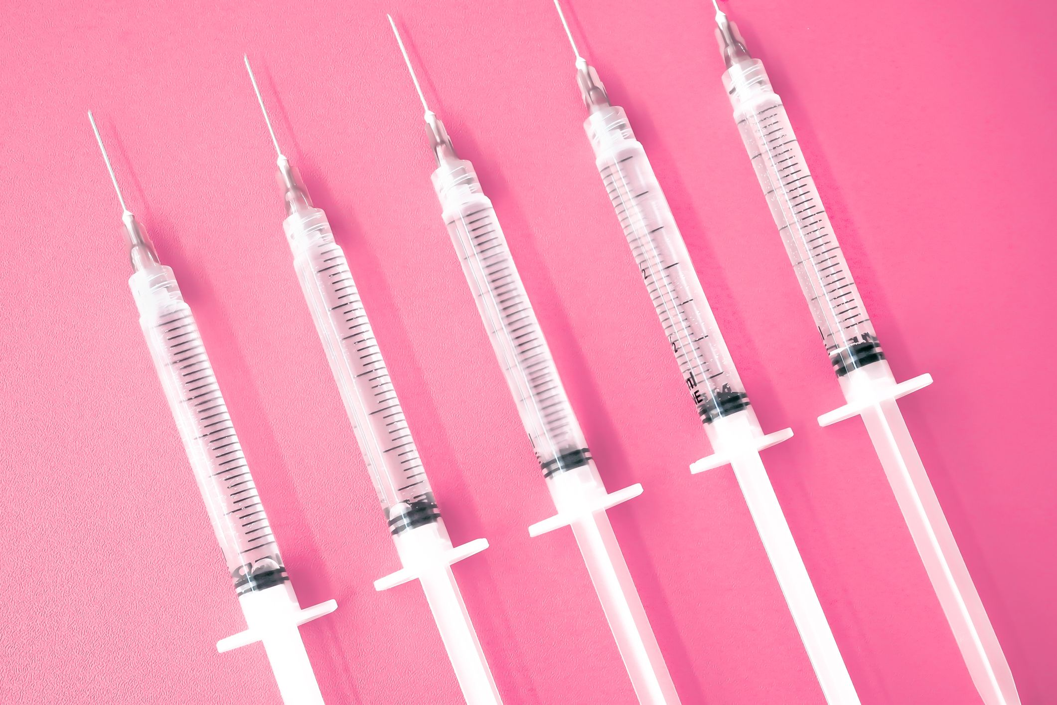 https://hips.hearstapps.com/hmg-prod/images/multiple-syringes-with-needles-on-pink-background-royalty-free-image-1674750756.jpg