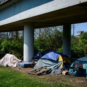 multiple tents rest underneath an overpass in east nashville