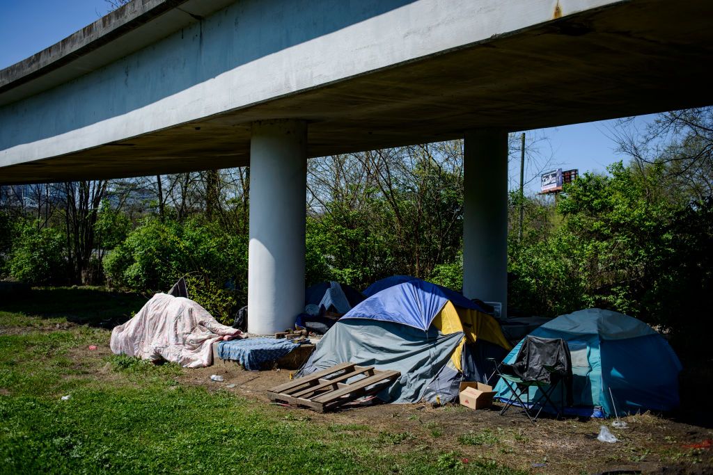 multiple tents rest underneath an overpass in east nashville