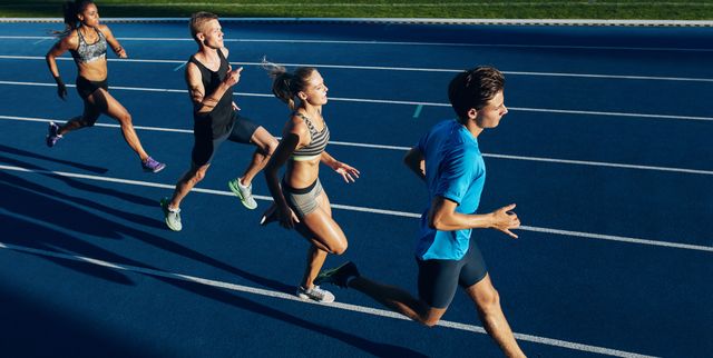 Multiracial athletes practicing running on racetrack