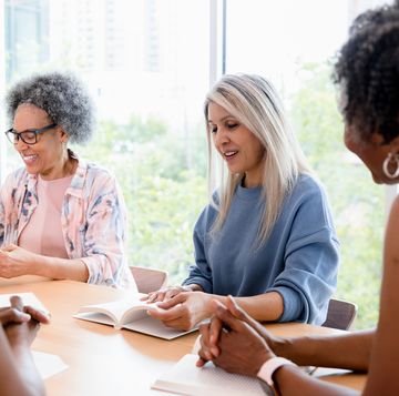 multiracial group of women enjoy meeting to discuss book
