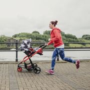 Multitasking Mother Running With Pushcair
