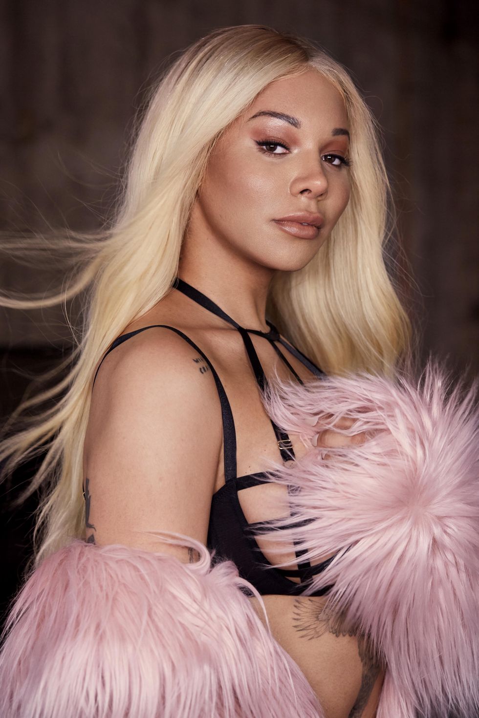 https://hips.hearstapps.com/hmg-prod/images/munroe-bergdorf-with-pink-pom-pom-bluebella-loveyourself-campaign-1548849417.jpg?crop=1xw:1xh;center,top&resize=980:*
