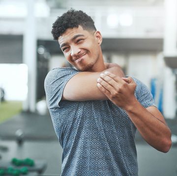 shot of a young man experiencing neck pain in a gym