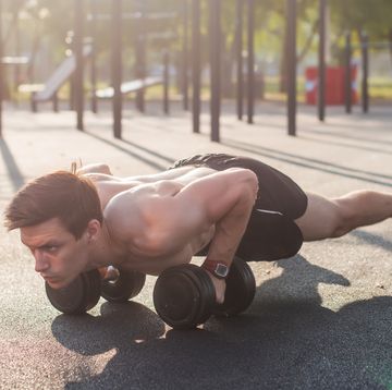 muscular male athlete doing push ups exercises