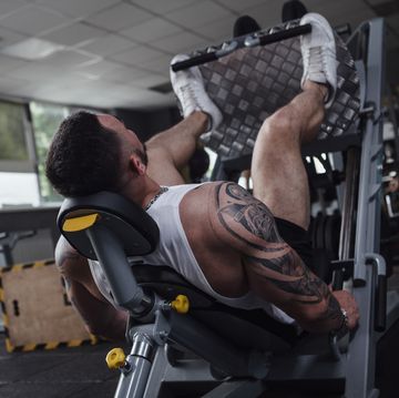 muscular male bodybuilder working out at gym