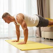 muscular man doing push ups during home workout