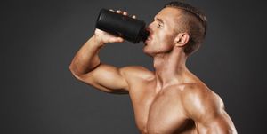 Muscular man with protein drink in shaker