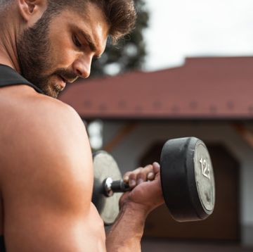 muscular young man exercising in backyard