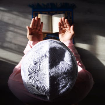 a muslim man is doing salah at home