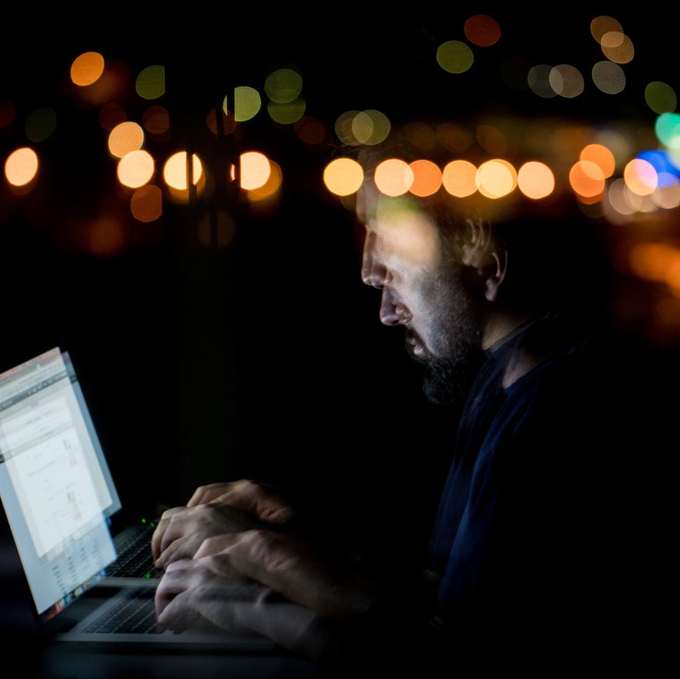 abstract image of man late at night using laptop
