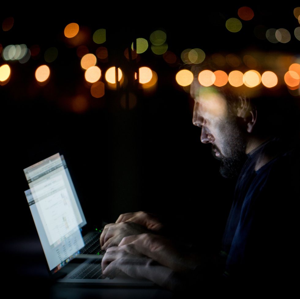 abstract image of man late at night using laptop