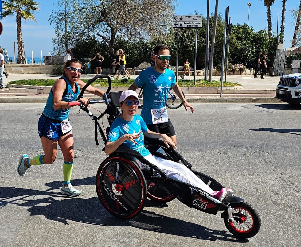 a man and woman with a child on a tricycle