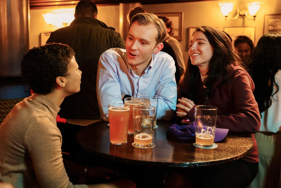 three friends at a bar