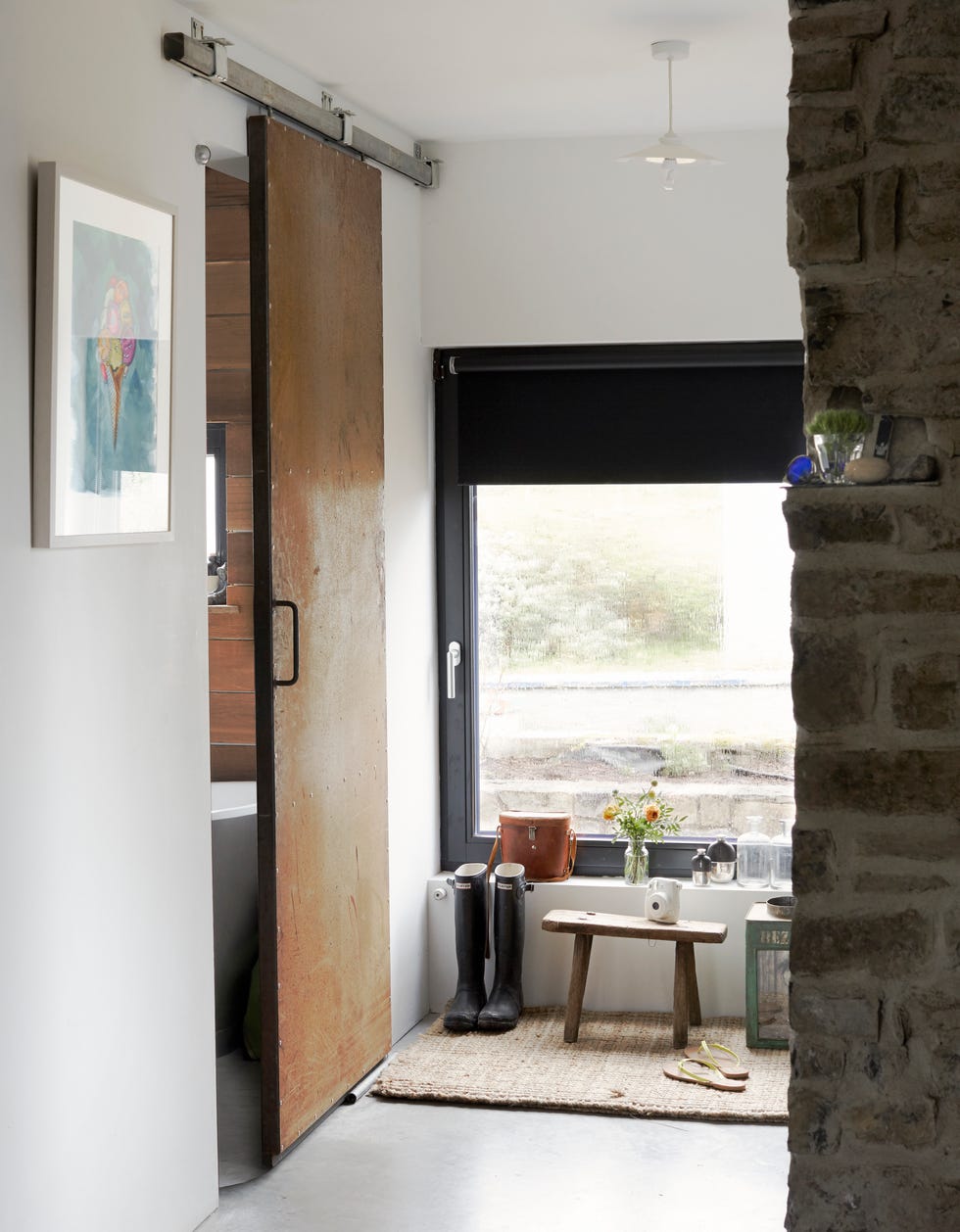 hallway with wooden sliding door to bathroom