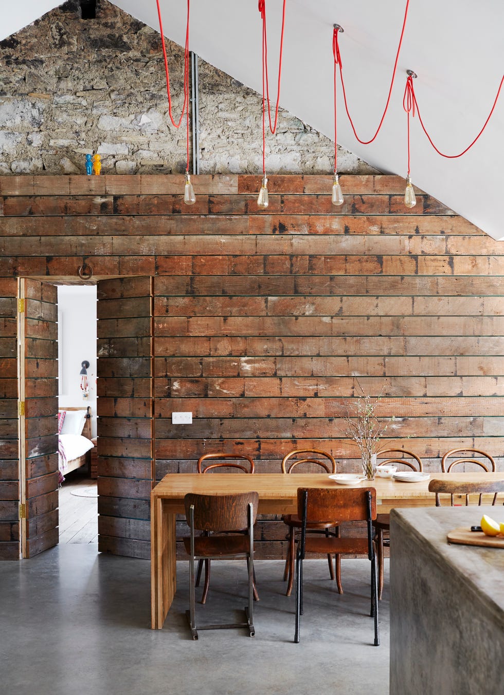 industrial looking kitchen with panelled wall exposed wall and concrete floor