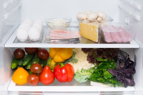 n a white refrigerator, food stock, on the top shelf eggs, fish, mushrooms, cottage cheese, meat, cheese, and vegetables on the bottom