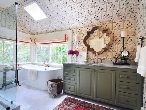 large bathroom with floor to ceiling wallpaper, green vanity and soaking tub