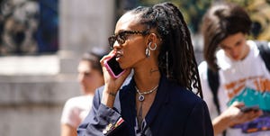 paris, france   june 22 a guest wears tortoise shell pattern sunglasses, a necklace, a navy blue jacket with a lavaliere, outside thom browne, during paris fashion week   menswear springsummer 2020, on june 22, 2019 in paris, france photo by edward berthelotgetty images