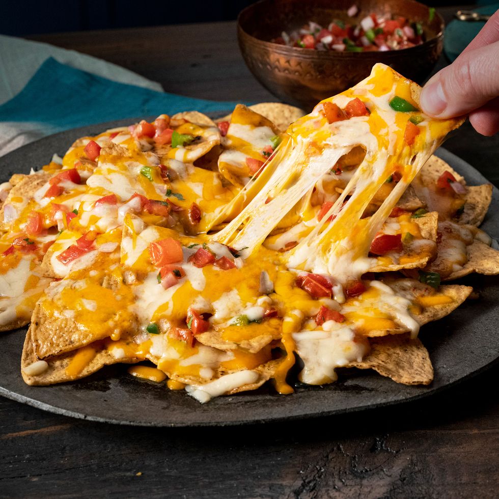 a plate of cheesy nachos