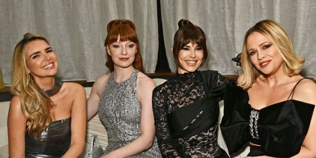 girls alouds nadine coyle, nicola roberts, cheryl cole and kimberly walsh sit on a couch in formal wear