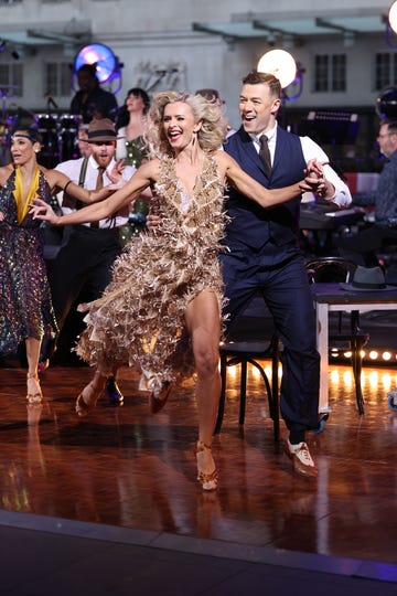 nadiya bychkova and kai widdrington dancing on a stage