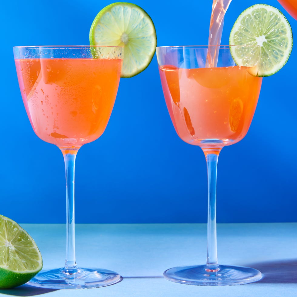naked and famous cocktail in a glass with a lime wheel