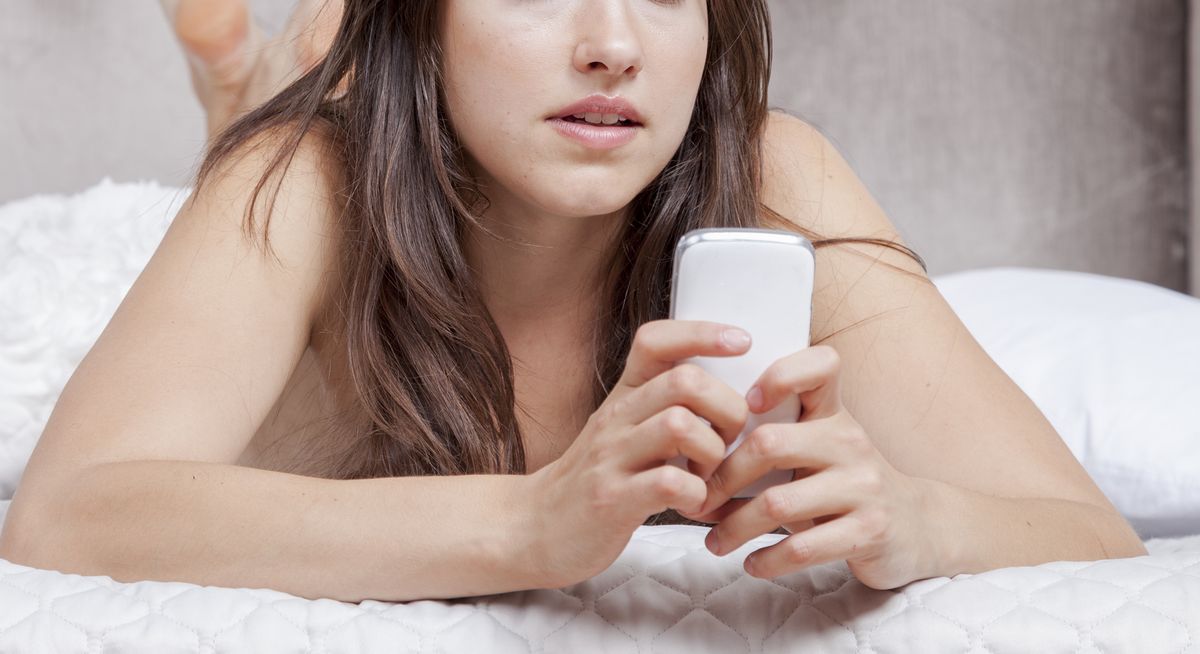 woman in bed with smart phone