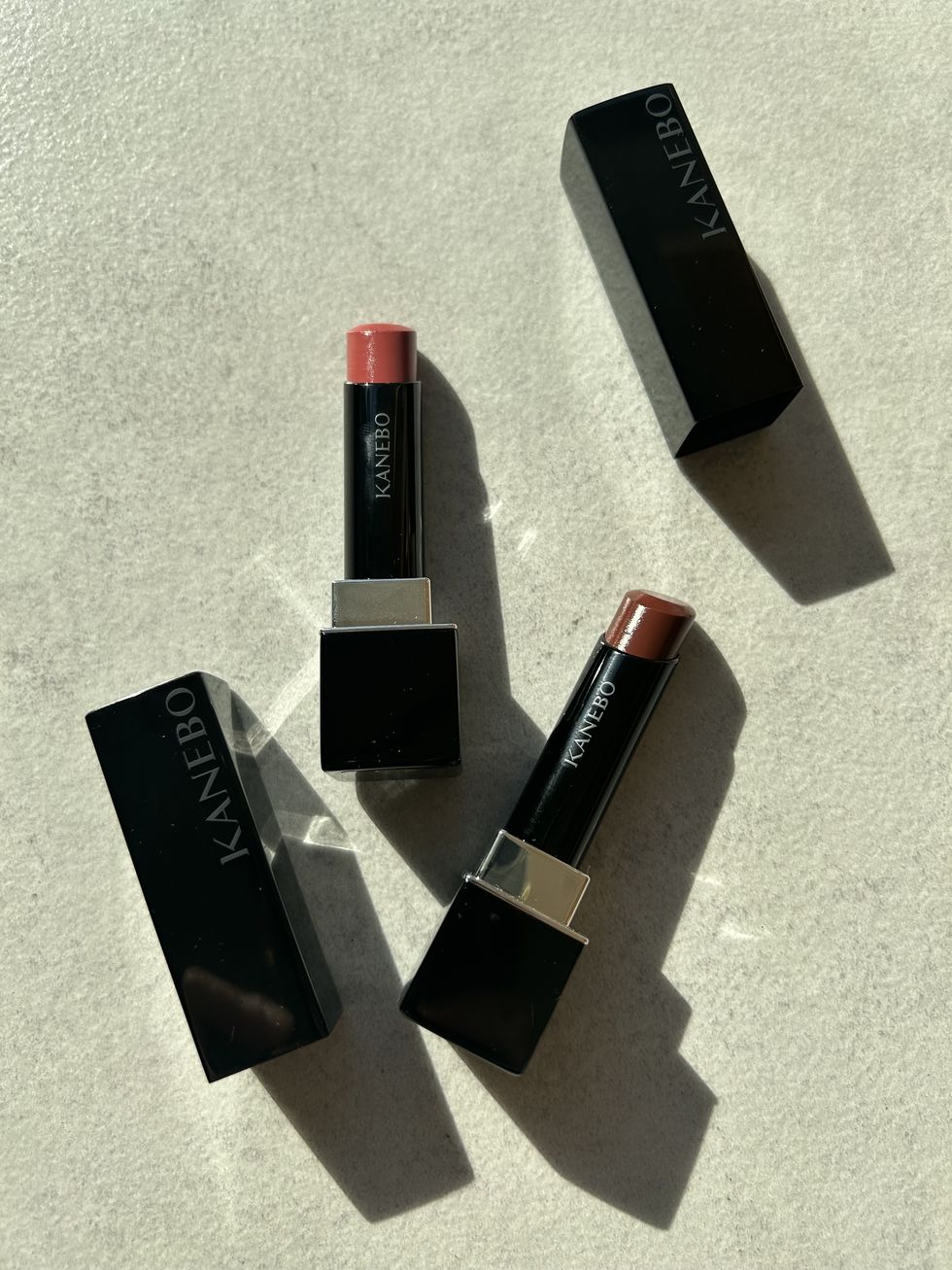 a group of different colored lipsticks