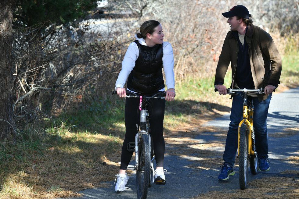 naomi biden the granddaughter of us president joe biden and her fiancé peter neal ride bikes in nantucket, massachusetts