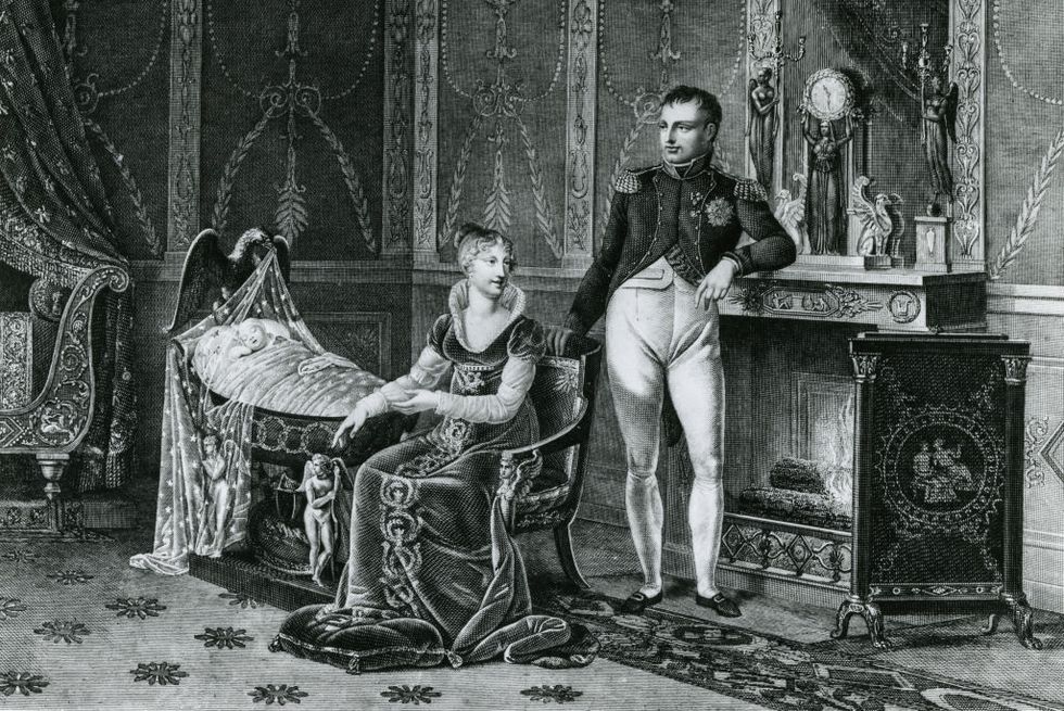 drawing showing napoleon bonaparte standing with his seated wife and infant son in a crib nearby