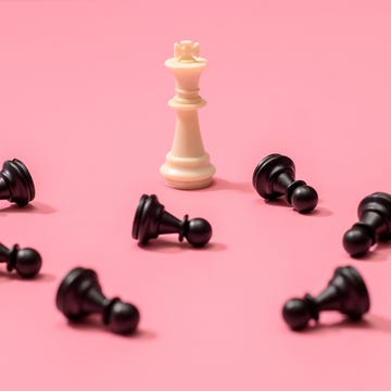 narcissism types — chess piece and fallen pawns chess piece king and fallen pawn on pink background