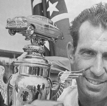 ned jarrett holding his trophy from nascar 1965 southern 500