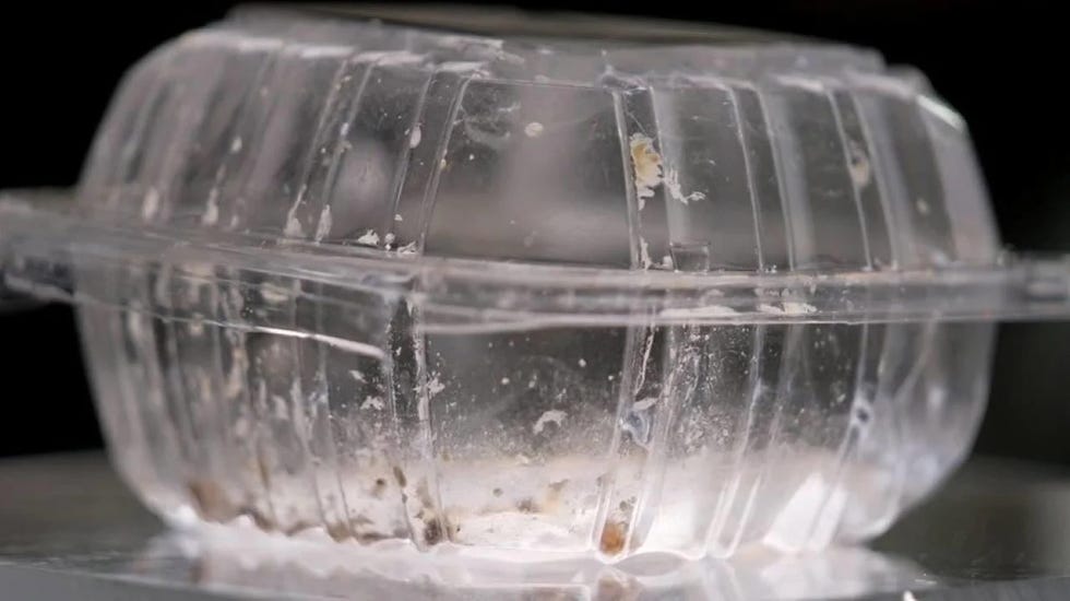 takeout container with remnants of food inside